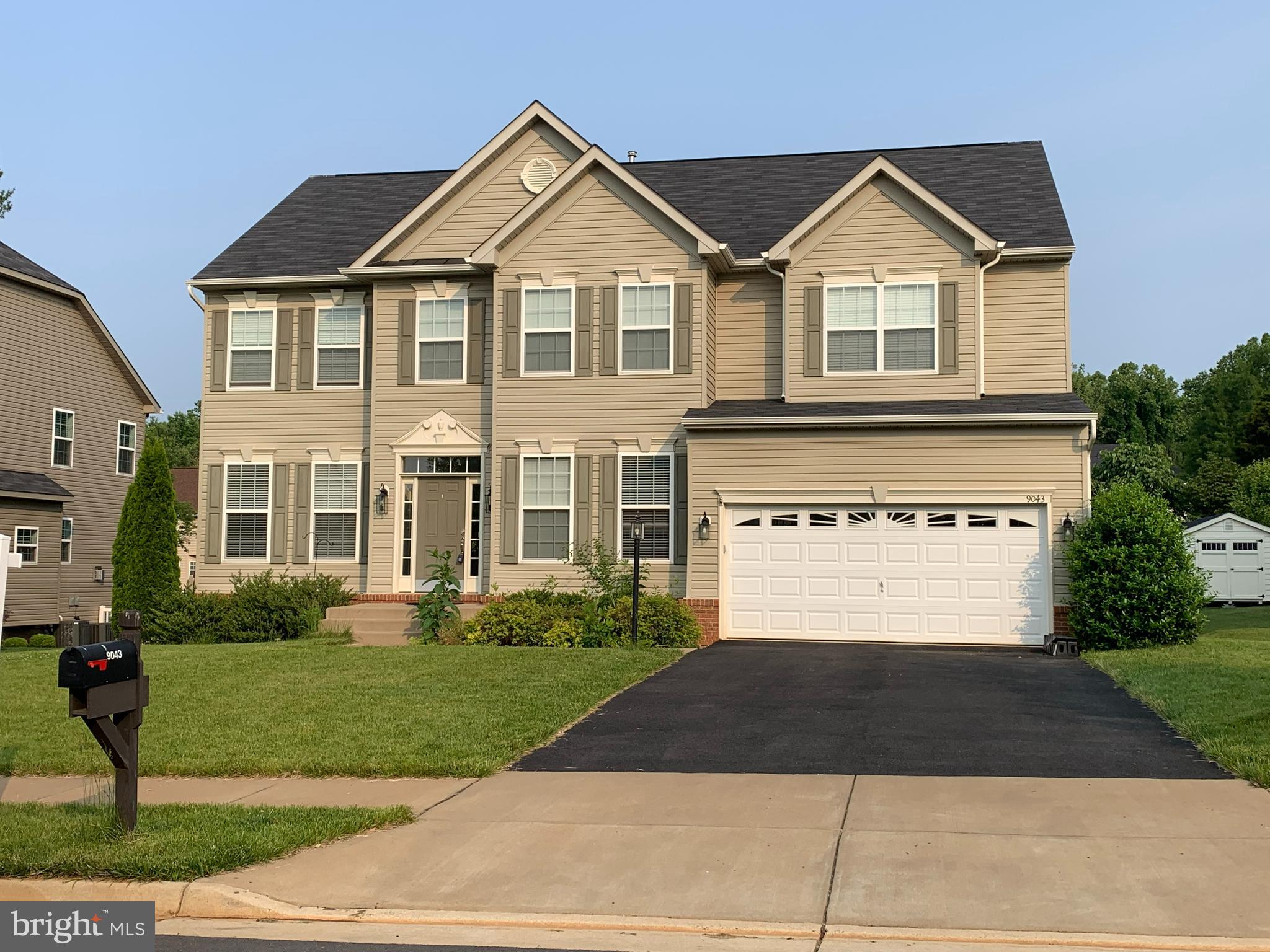 9043 Stone Crest Drive Warrenton, VA 20186 - Photo 1 of 94 a front view of a house with a yard and garage