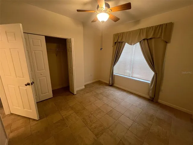 an empty room with windows and entryway