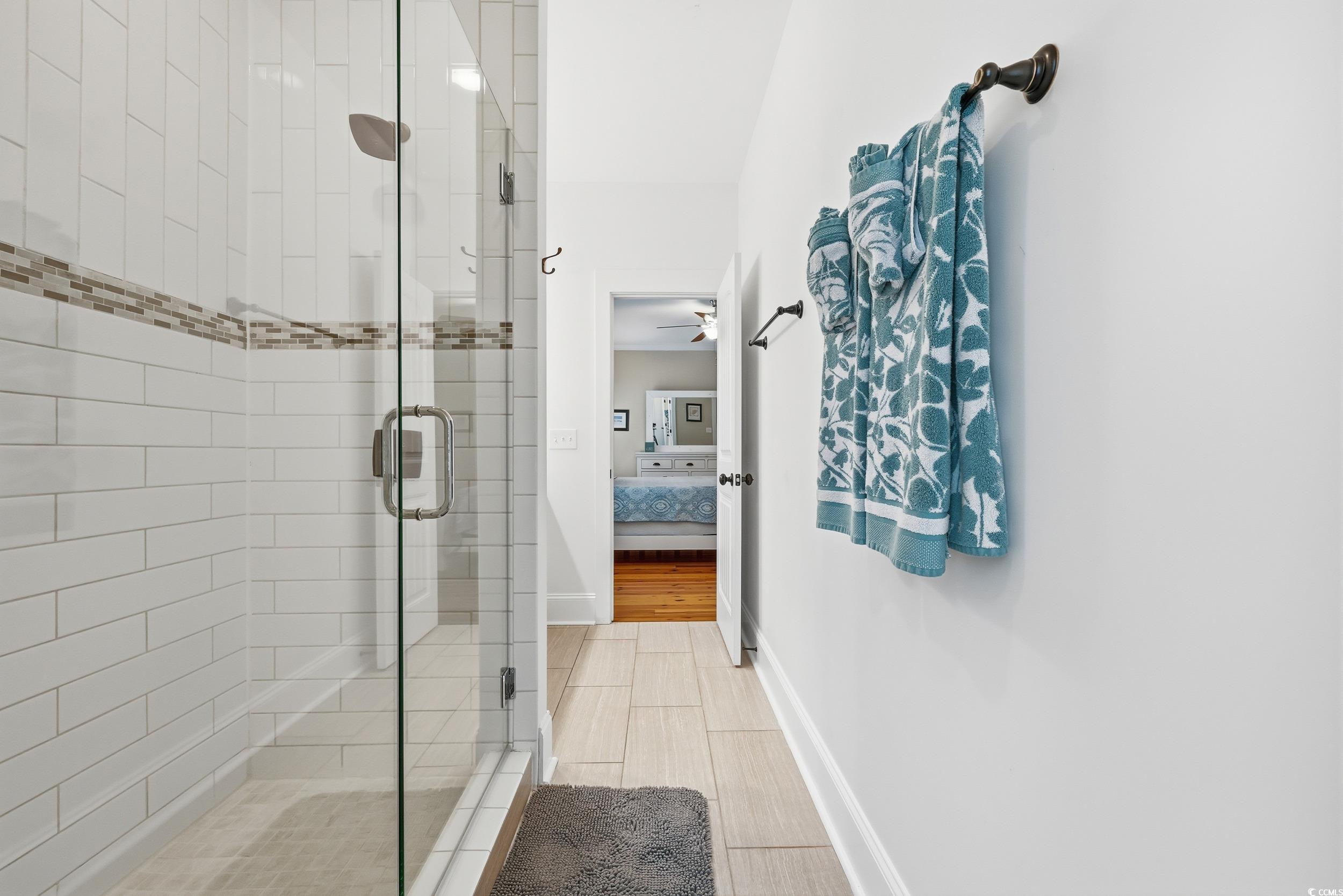 43 Sandlapper Way Pawleys Island, SC 29585 - Photo 15 of 33 Bathroom featuring ensuite bath, a stall shower, a ceiling fan, and light wood finished floors