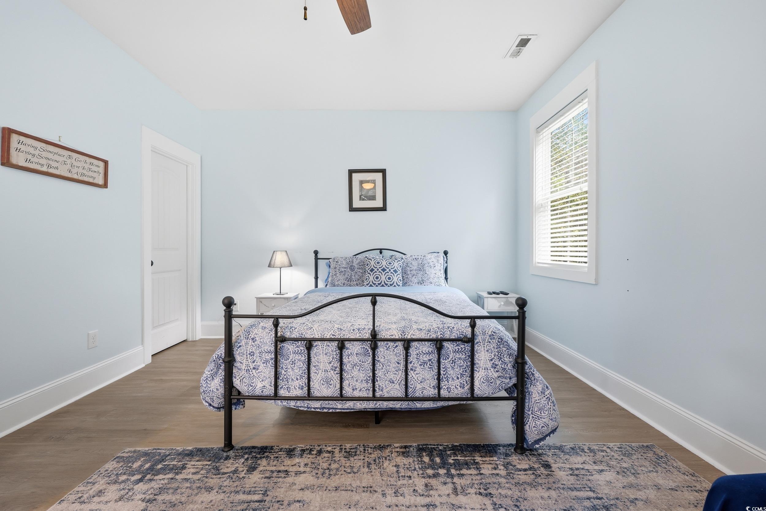 43 Sandlapper Way Pawleys Island, SC 29585 - Photo 16 of 33 Bedroom with dark wood finished floors and ceiling fan
