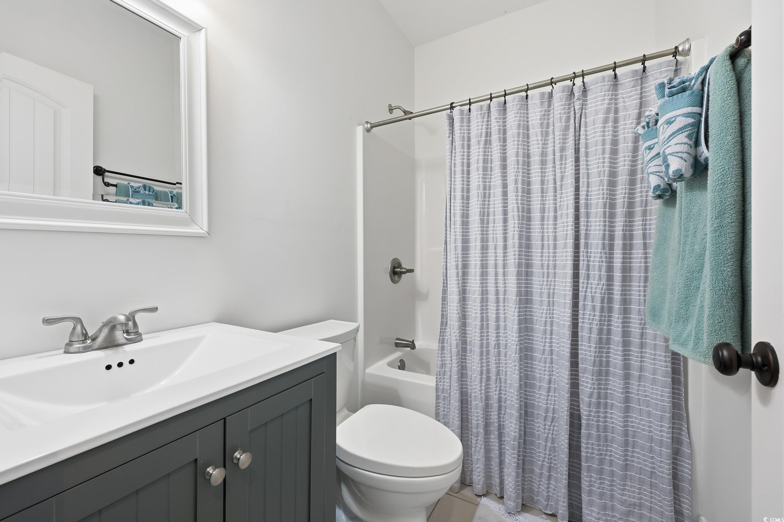 43 Sandlapper Way Pawleys Island, SC 29585 - Photo 17 of 33 Bathroom featuring vanity and shower / bath combination with curtain