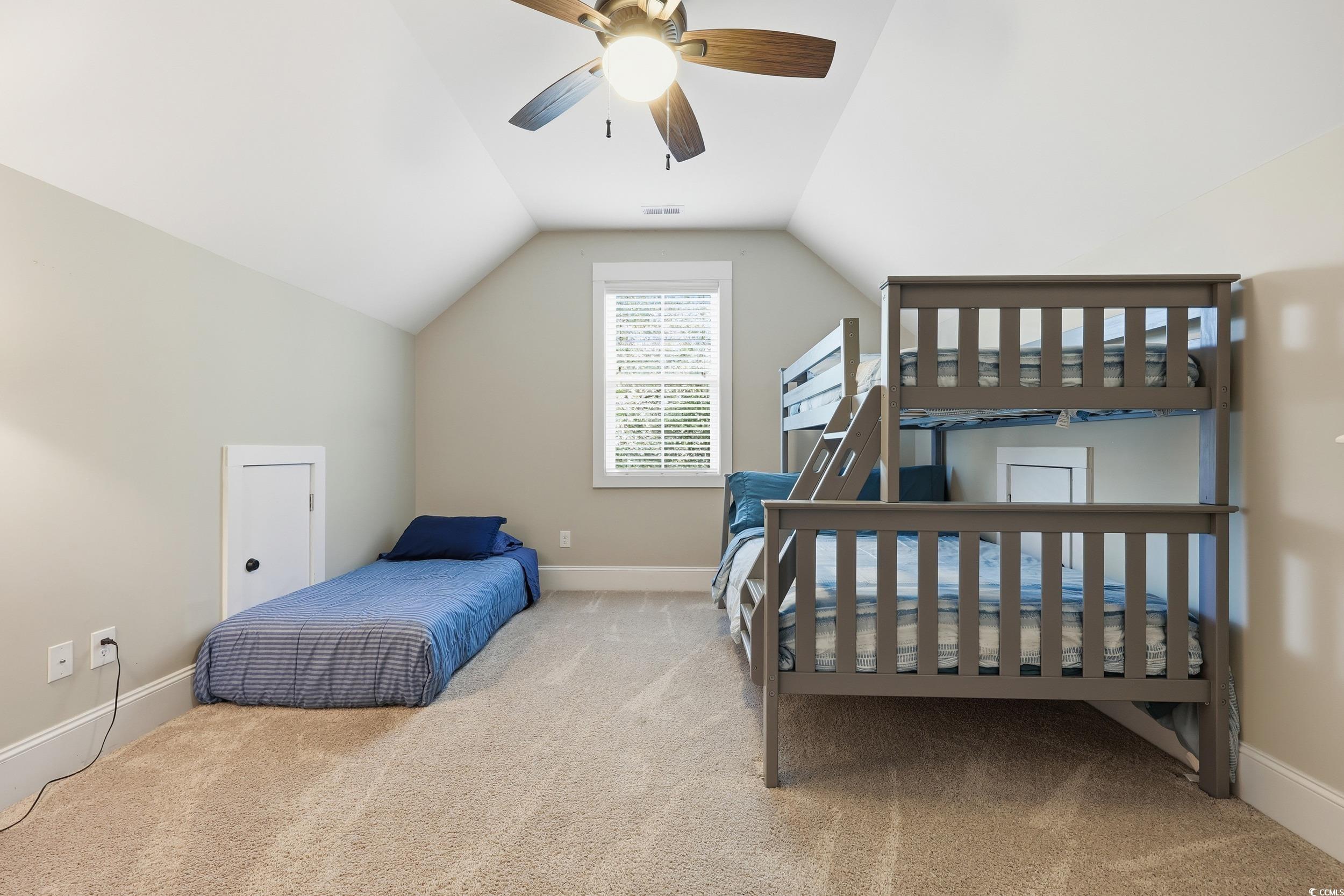 43 Sandlapper Way Pawleys Island, SC 29585 - Photo 18 of 33 Bedroom featuring light carpet, vaulted ceiling, and ceiling fan