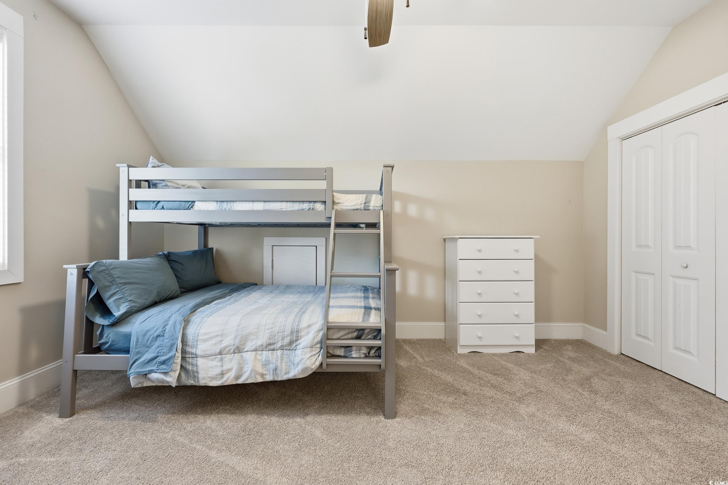 43 Sandlapper Way Pawleys Island, SC 29585 - Photo 19 of 33 Bedroom with light colored carpet, vaulted ceiling, a ceiling fan, and a closet