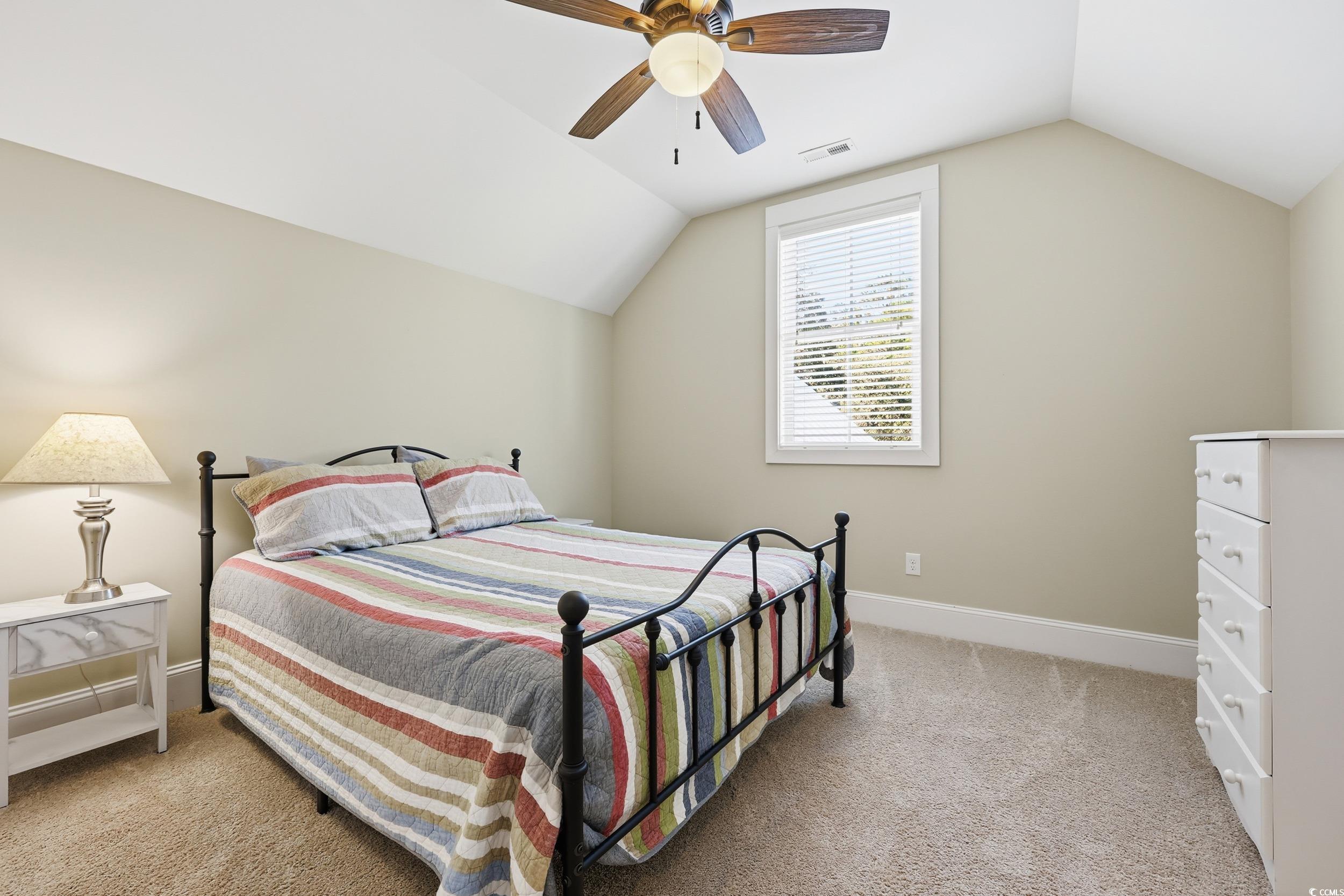 43 Sandlapper Way Pawleys Island, SC 29585 - Photo 20 of 33 Bedroom with light carpet, lofted ceiling, and a ceiling fan