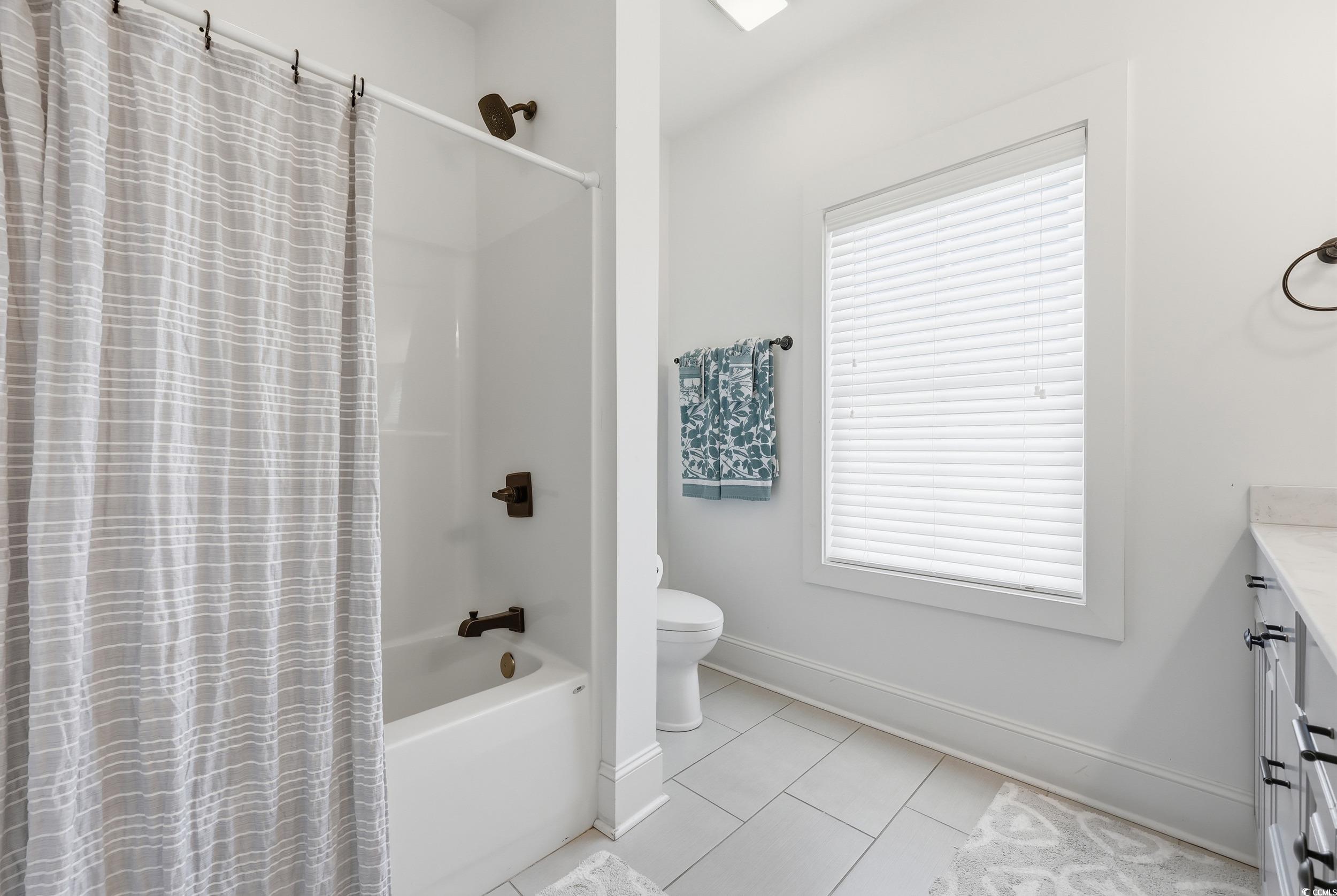 43 Sandlapper Way Pawleys Island, SC 29585 - Photo 22 of 33 Full bath with vanity, light tile patterned floors, and shower / tub combo