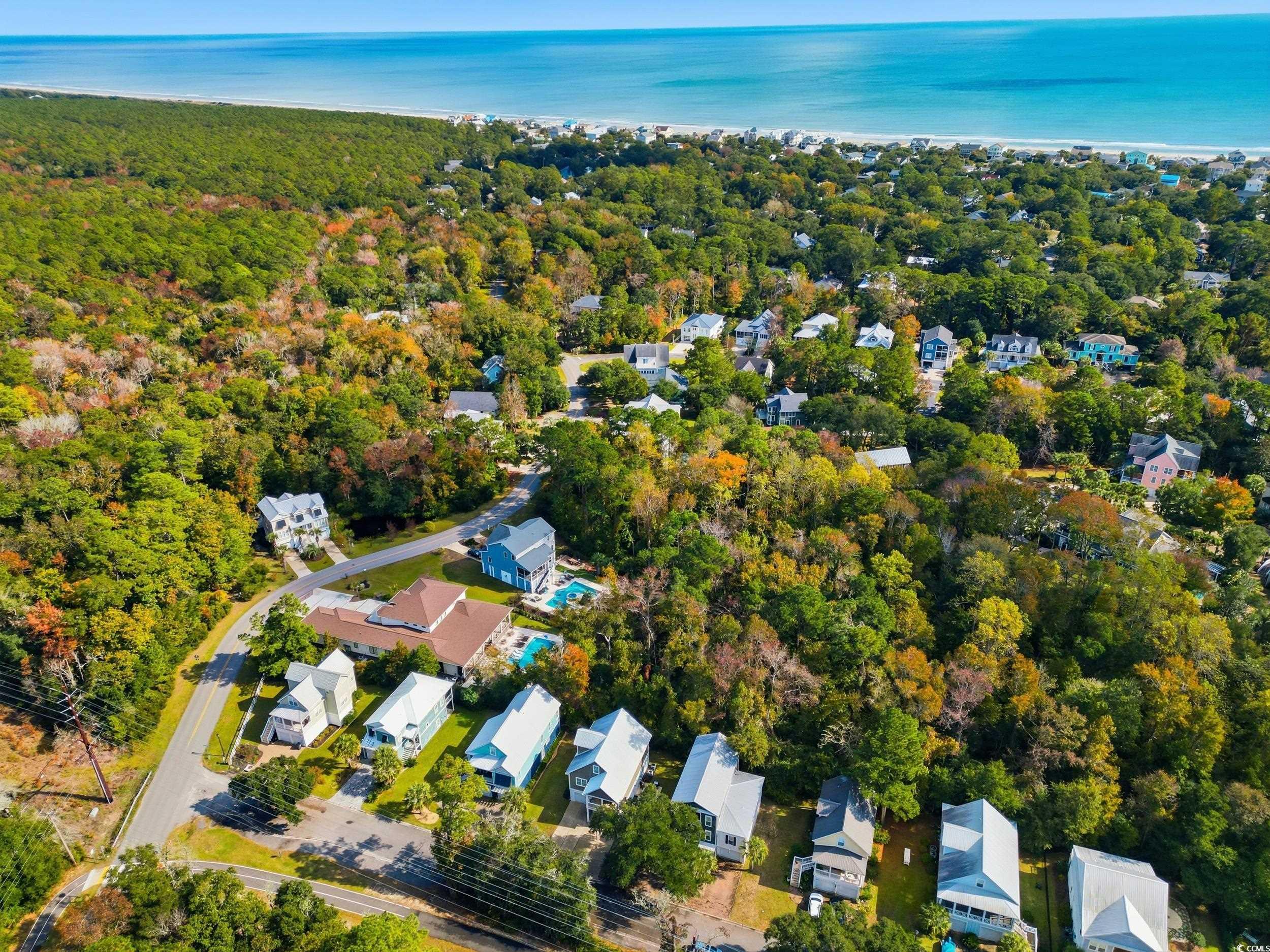 43 Sandlapper Way Pawleys Island, SC 29585 - Photo 29 of 33 Aerial view of property and surrounding area with nearby suburban area and a large body of water