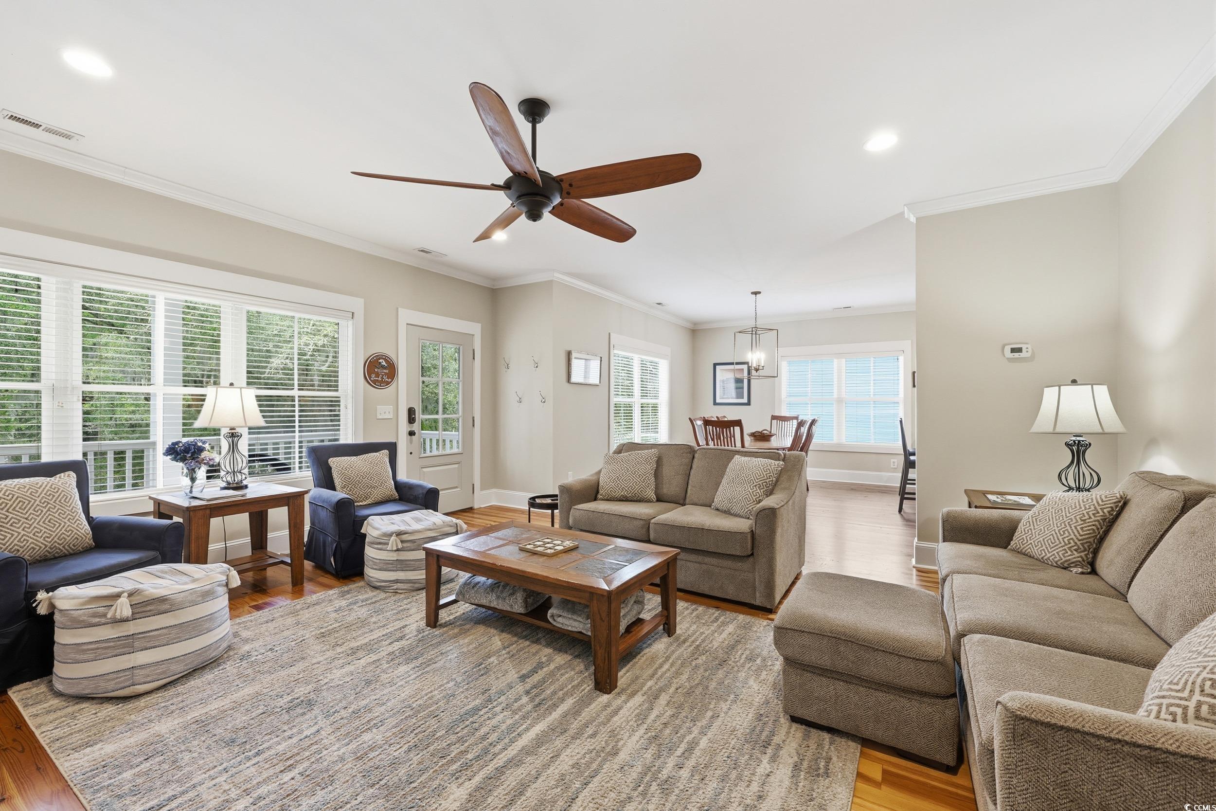 43 Sandlapper Way Pawleys Island, SC 29585 - Photo 5 of 33 Living area with recessed lighting, crown molding, light wood-type flooring, and ceiling fan