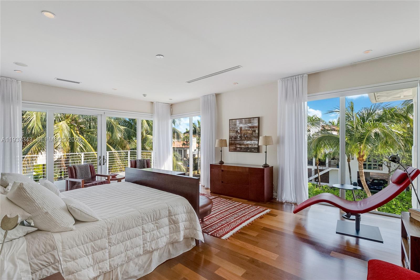 3835 Carole Court Miami, FL 33133 - Photo 27 of 41 a bedroom with a bed a table and large windows