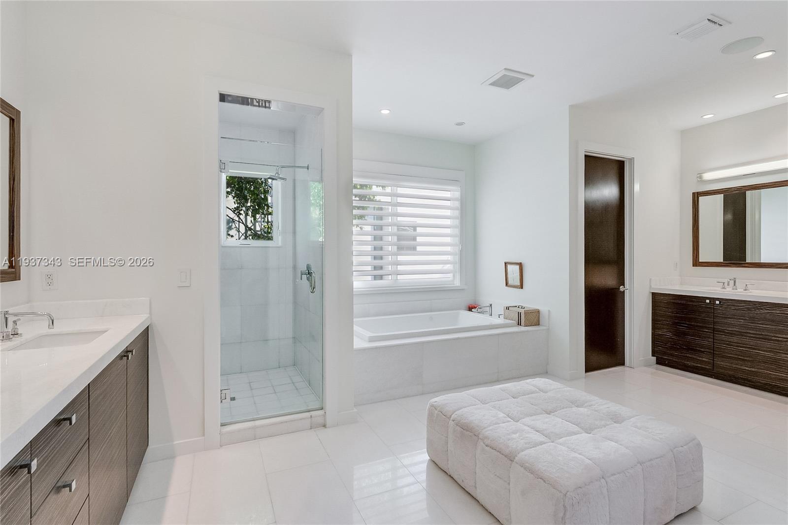3835 Carole Court Miami, FL 33133 - Photo 28 of 41 a spacious bathroom with a tub sink shower and mirror