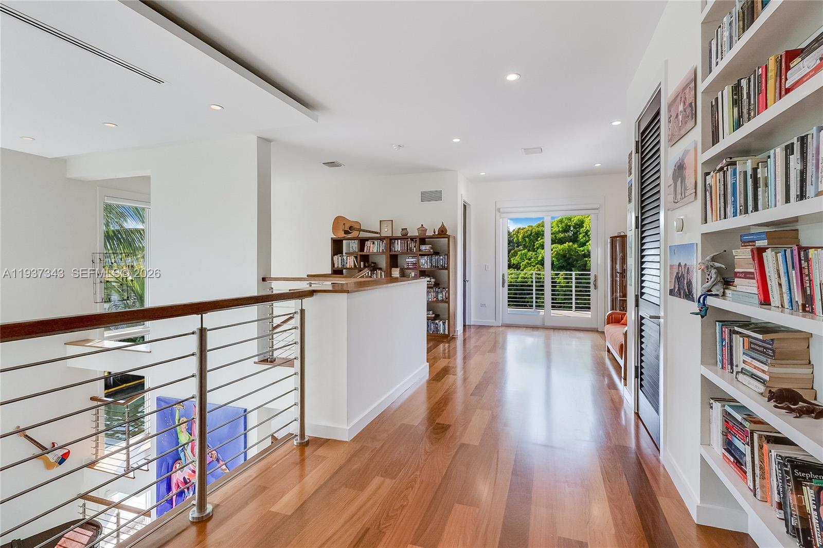 3835 Carole Court Miami, FL 33133 - Photo 32 of 41 a view of a hallway with wooden floor and furniture