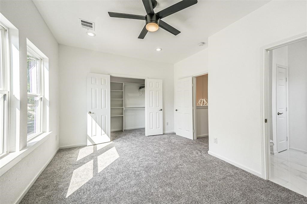 5317 Chennault Road, Unit A Houston, TX 77033 - Photo 8 of 11 a view of empty room with a ceiling fan and window