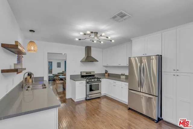 a kitchen with granite countertop a sink and a stove