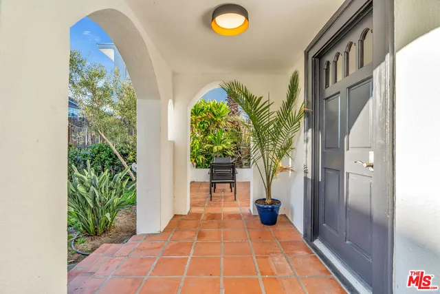 a view of a patio with table and chairs potted plants