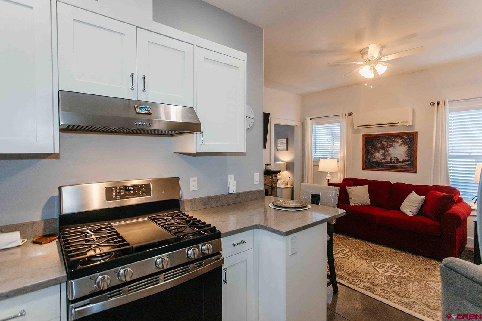 13457 6175th Road Montrose, CO 81403 - Photo 37 of 45 a kitchen with stainless steel appliances granite countertop a sink stove and cabinets