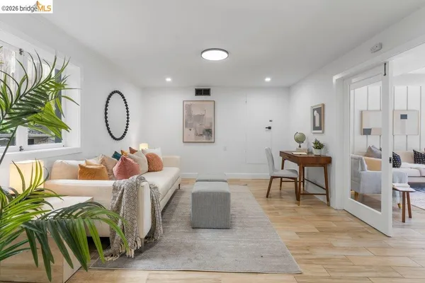 a living room with furniture and wooden floor