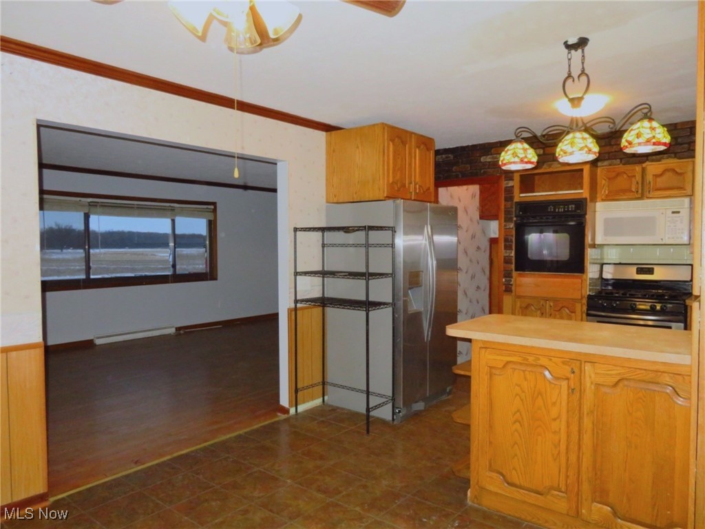 12214 Thompson Road Vermilion, OH 44089 - Photo 8 of 29 The living room opens to the eat-in-kitchen