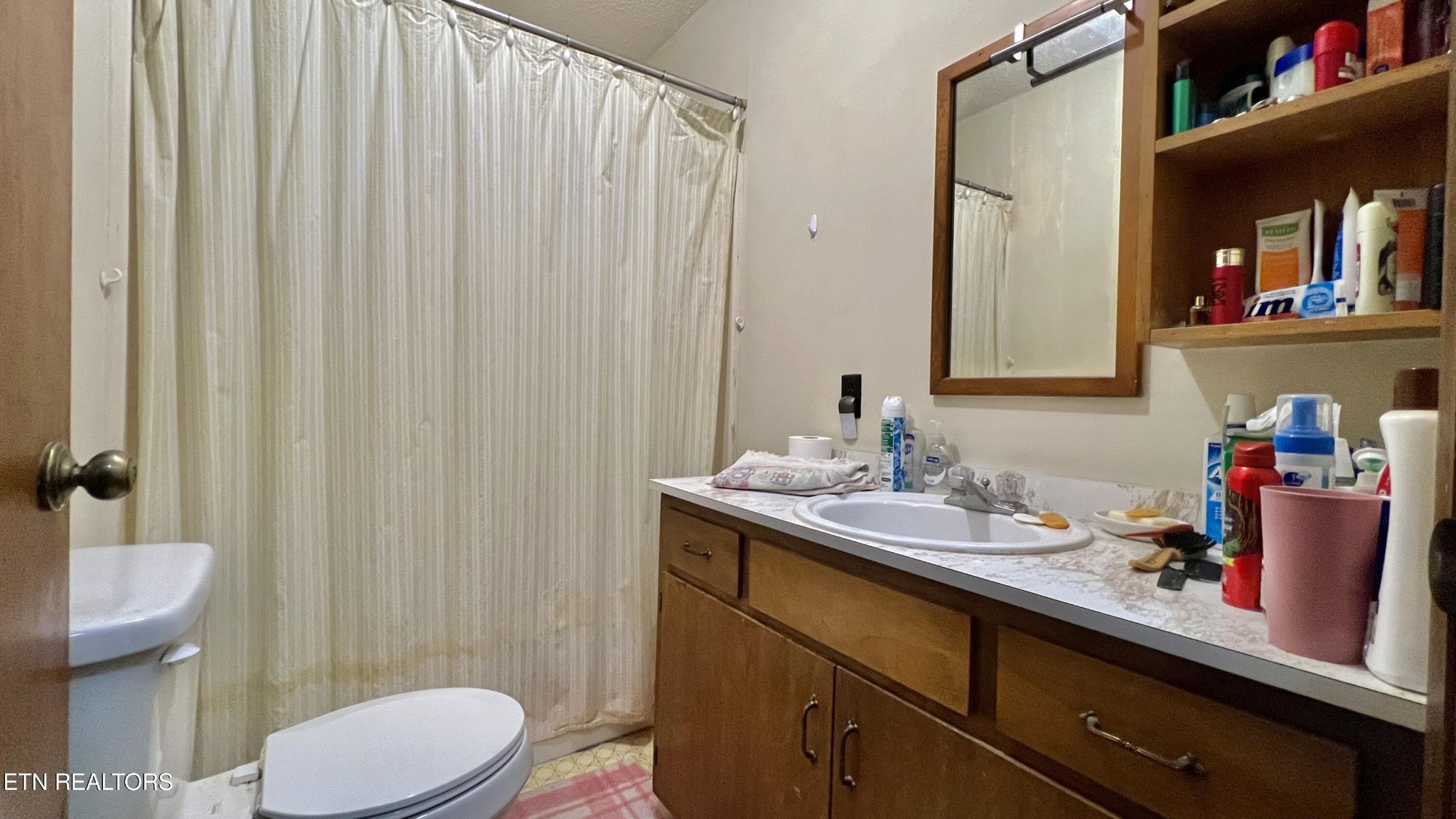 1803 Elkins Road Kodak, TN 37764 - Photo 54 of 58 a bathroom with a sink a toilet and shower curtain