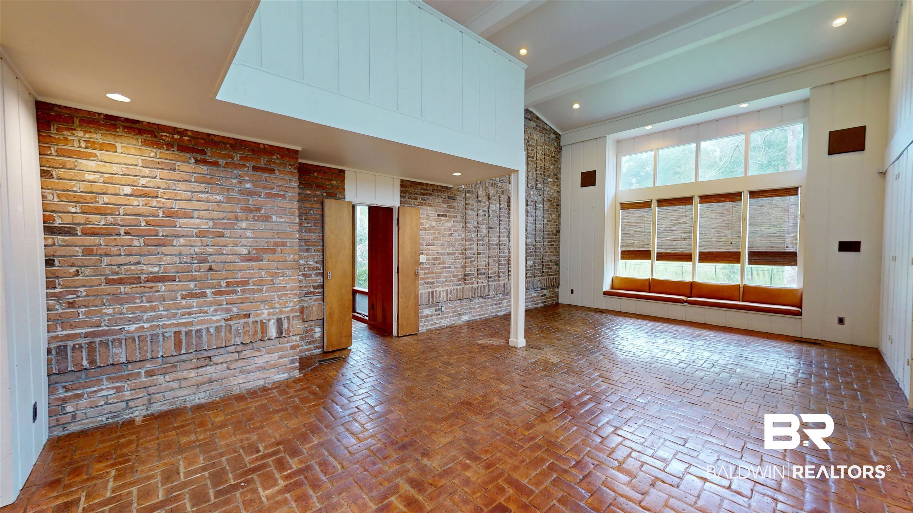 15 Spring Bank Road Mobile, AL 36608 - Photo 29 of 58 Unfurnished great room featuring brick flooring, beamed ceiling, recessed lighting, brick wall, and high vaulted ceiling