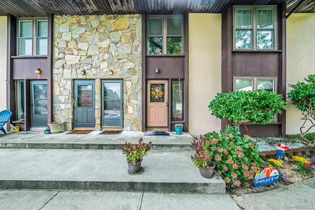 front view of a house with a potted plant