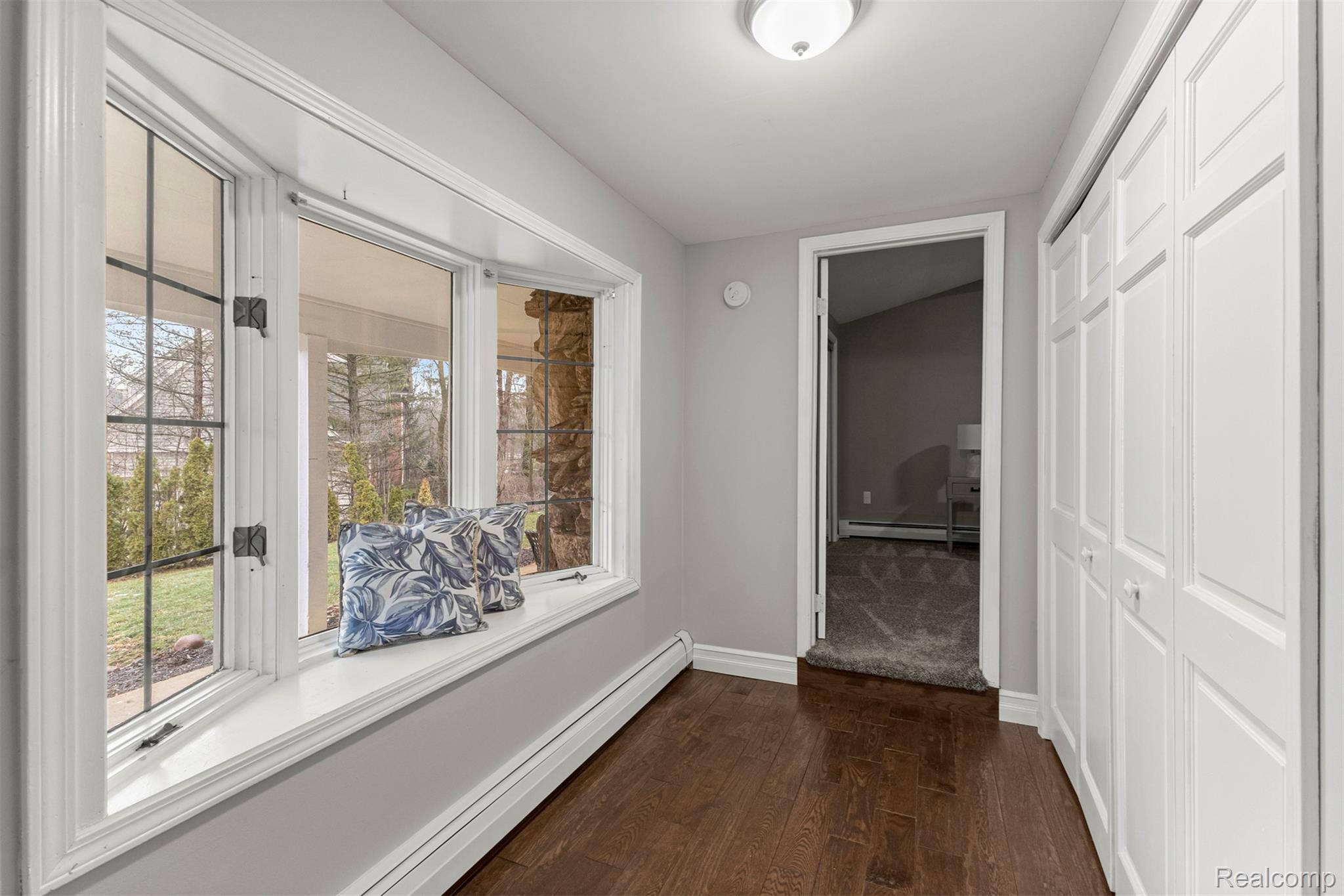 45401 West 9 Mile Road Novi, MI 48374 - Photo 19 of 67 Hallway with a baseboard heating unit, dark wood-style flooring, and baseboard heating