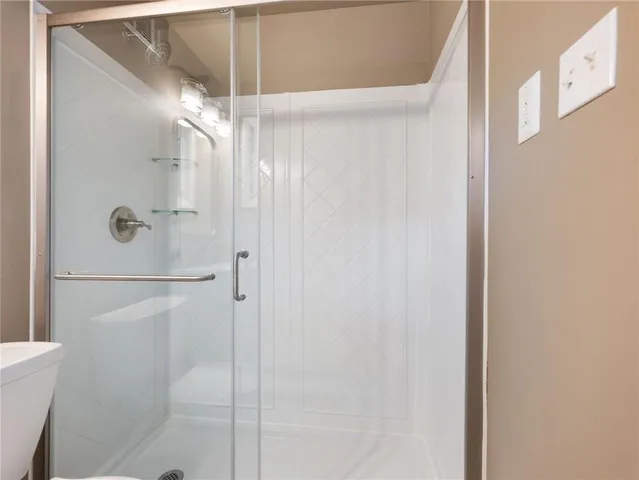 an empty room with a window and a chandelier fan