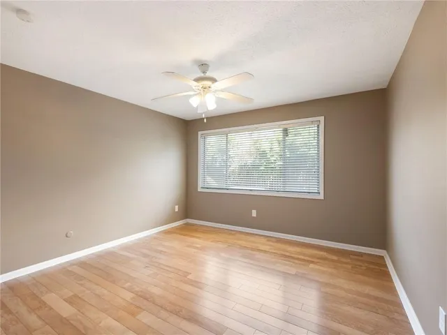 a bathroom with a bathtub shower sink vanity mirror and toilet