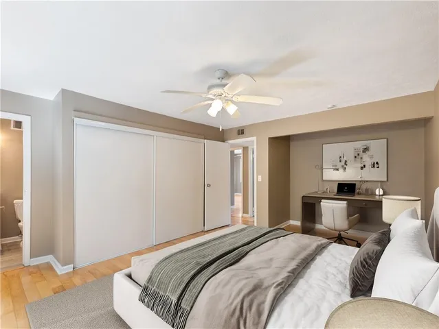 a bedroom with a large bed and a chandelier