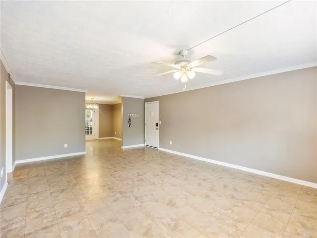 an empty room with wooden floor and natural light