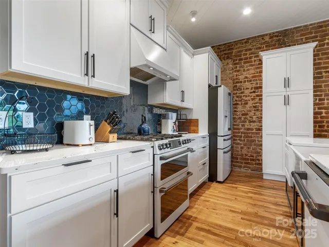 a kitchen with a stove cabinets and a sink
