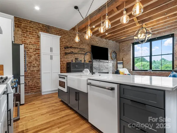 a kitchen with stainless steel appliances kitchen island granite countertop a sink and cabinets