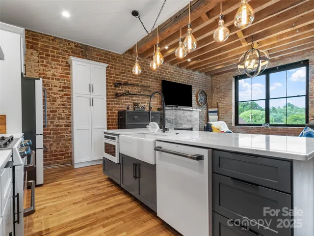 a kitchen with stainless steel appliances kitchen island granite countertop a sink and cabinets