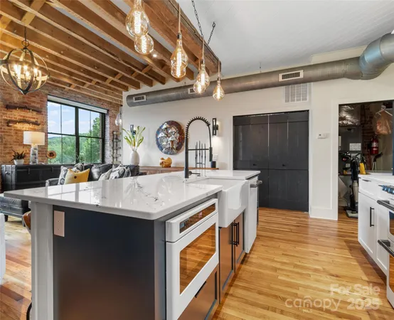 a kitchen with stainless steel appliances granite countertop a sink and cabinets