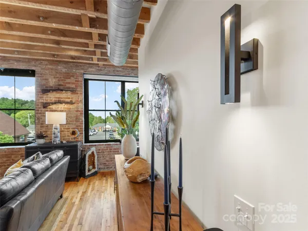 a view of a livingroom with furniture and floor to ceiling window