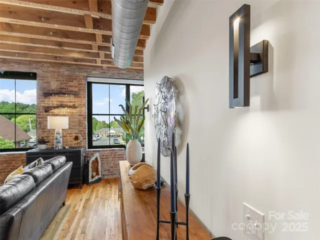 a view of a livingroom with furniture and floor to ceiling window