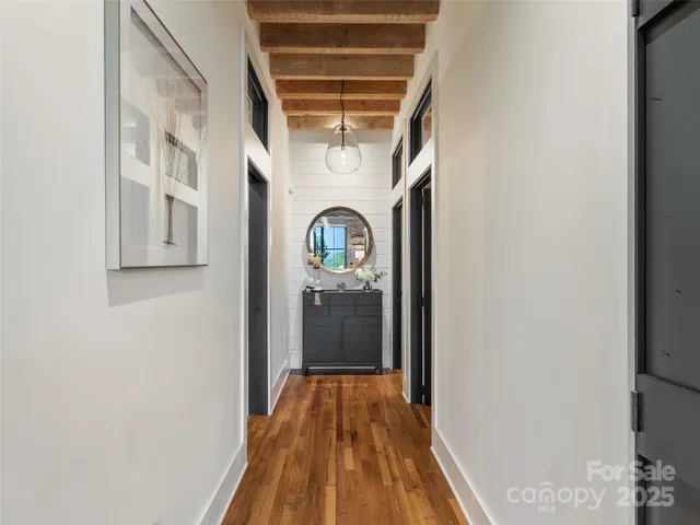a view of a hallway with wooden floor
