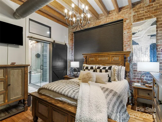 a bedroom with a bed tv and a fireplace