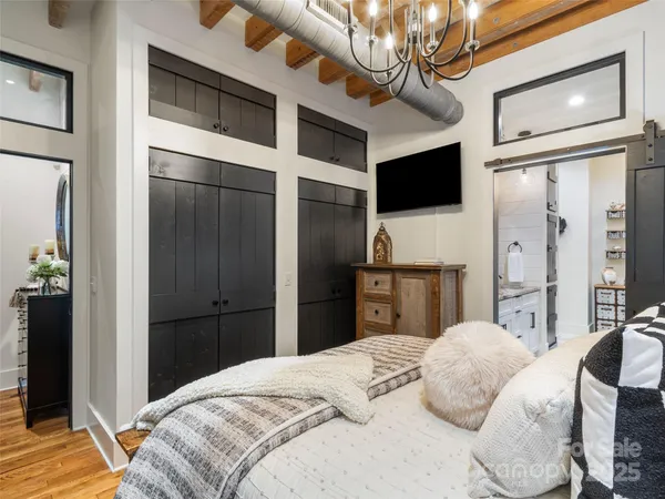 a bedroom with a bed and a flat screen tv