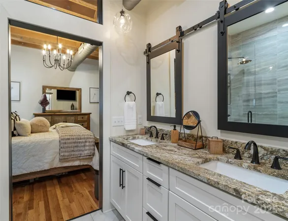 a en suite bathroom with a double vanity sink and a mirror