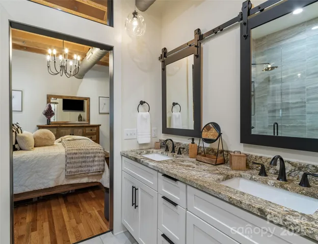 a en suite bathroom with a double vanity sink and a mirror