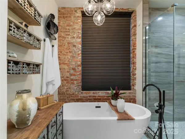 a bathroom with a tub sink and mirror