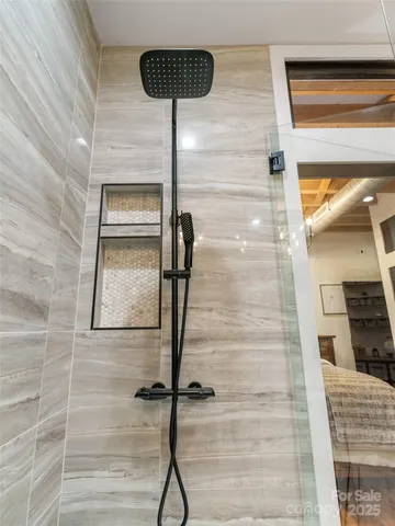 a bathroom with a toilet and a shower