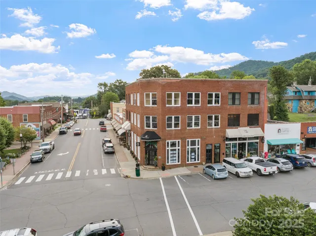 an aerial view of multiple houses with yard