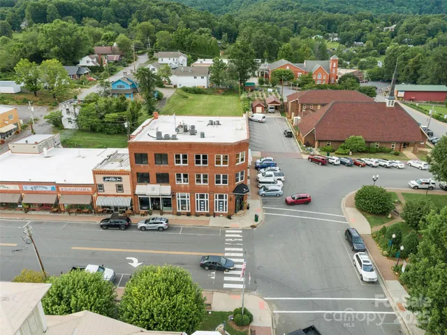 a view of a street with a cars parked