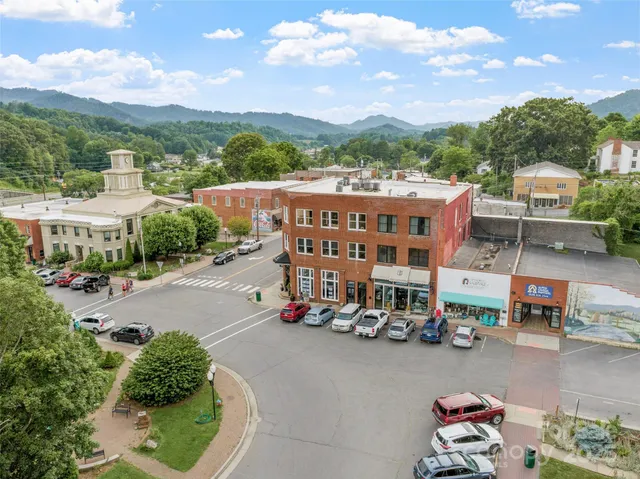 a city street lined with cars parked in front of it