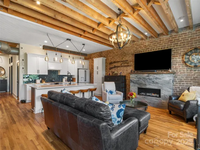 a living room with fireplace furniture and a flat screen tv