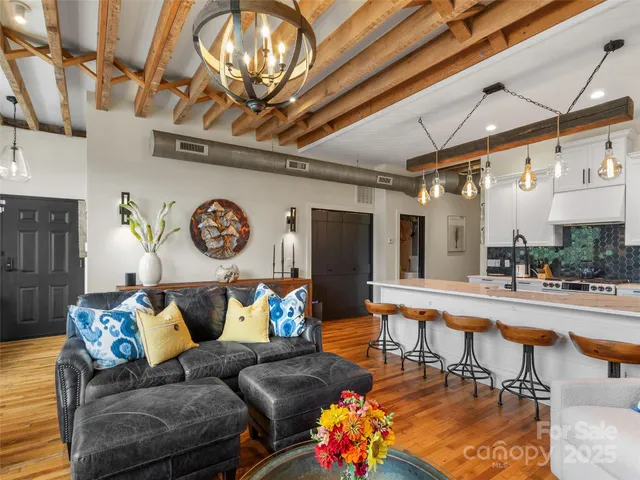 a living room with furniture and a chandelier