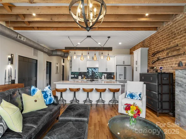 a living room with lots of furniture and a chandelier