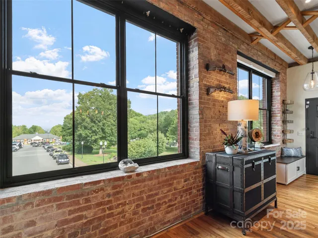 a living room filled with furniture and a floor to ceiling window