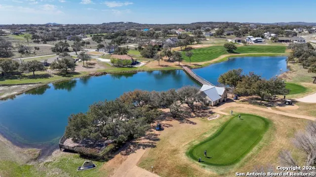 an aerial view of a house with a lake view