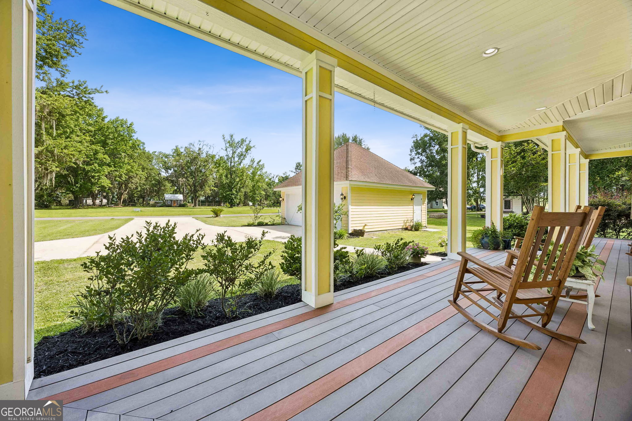 706 Hopewell Point Road White Oak, GA 31568 - Photo 63 of 84 The wraparound porch offers beautiful sightlines across the property while connecting the main home to the detached garage and surrounding outdoor spaces.